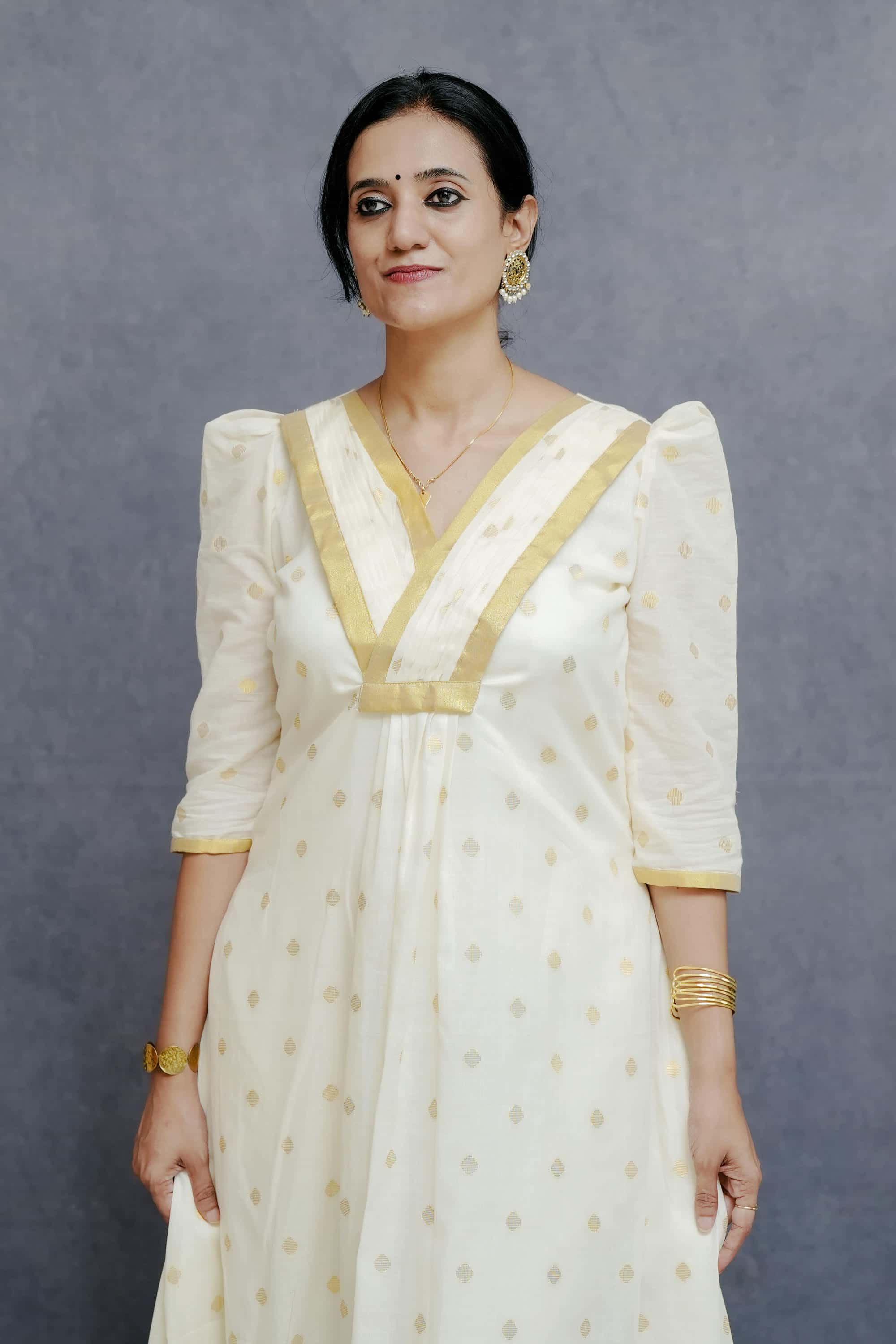 Off White A line Cotton Dress with Golden Plates & Highlights